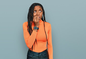 African american woman wearing casual clothes looking stressed and nervous with hands on mouth biting nails. anxiety problem.