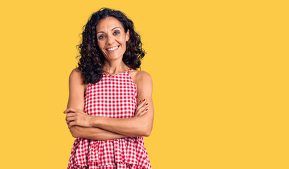 Middle age beautiful woman wearing casual sleeveless t shirt happy face smiling with crossed arms looking at the camera. positive person.