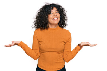 Young hispanic woman wearing casual clothes smiling showing both hands open palms, presenting and advertising comparison and balance