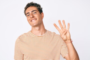 Young handsome man wearing casual clothes showing and pointing up with fingers number four while smiling confident and happy.