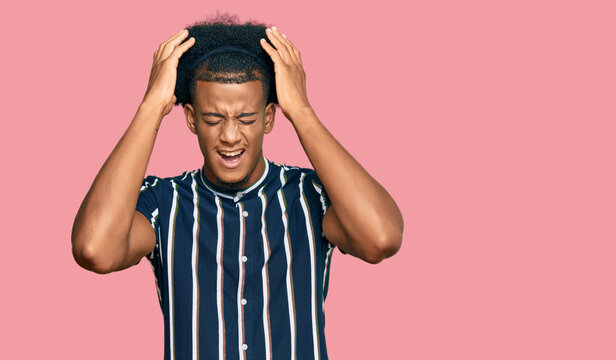 African american man with afro hair wearing casual clothes suffering from headache desperate and stressed because pain and migraine. hands on head.