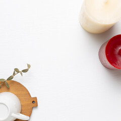 Empty mug cup with candles on white background. top view, copy space