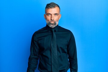 Middle age handsome man wearing business shirt and tie depressed and worry for distress, crying angry and afraid. sad expression.