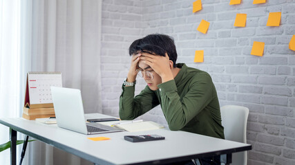 Naklejka premium Feeling tired. Young asian businessman feeling stress from work.