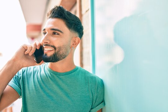 Young arab man with serious expression talking on the smartphone at the city.