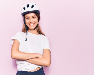 Young beautiful girl wearing bike helmet happy face smiling with crossed arms looking at the camera. positive person.