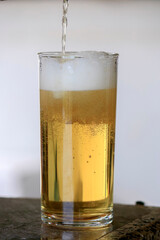 Beer in the glass and full of beer foam.