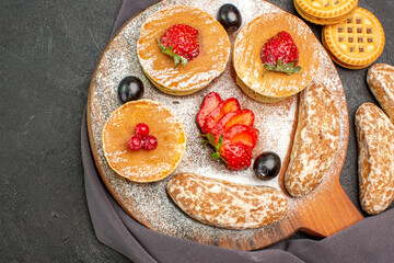 top view yummy pancakes with fruits and sweet cakes on dark desk dessert cake sweet