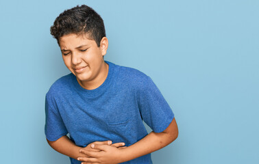 Teenager hispanic boy wearing casual clothes with hand on stomach because indigestion, painful illness feeling unwell. ache concept. © Krakenimages.com