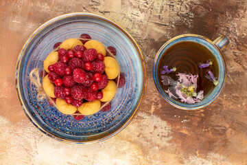 Freshly baked gift cake on a blue tray and a cup of tea on mixed color table stock image