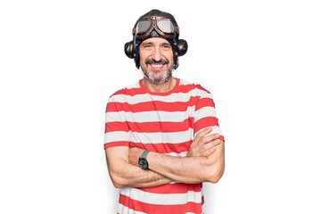 Middle age aviator man wearing vintage helmet and glasses over isolated white background happy face...