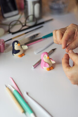 Cake decoration process. Baker uses the tools for sculpting fondant models. Edible art, cake...