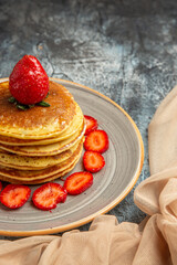 front view yummy pancakes with fresh strawberries on a light background cake sweet fruits