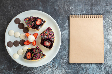 top view delicious cake slices with little cookies on dark desk dessert biscuit sweet
