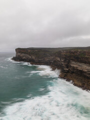 Cloudy view over sea cliff coastline.