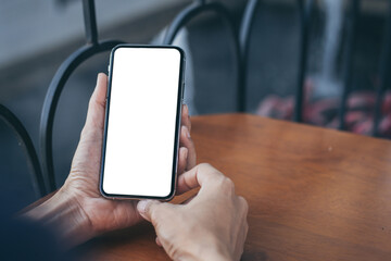 cell phone blank white screen mockup.woman hand holding texting using mobile on desk at office.background empty space for advertise.work people contact marketing business,technology