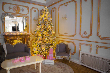 Festive interior: christmas tree and sofa with pillows, gifts. The concept of Christmas and the New year.