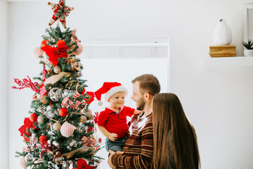 Happy Young Family Decorating Christmas 