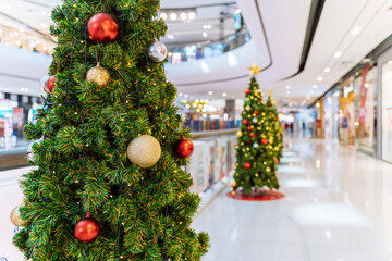 Christmas tree decoration in shopping mall, Shopping arcade soft focus with christmas tree, Department store scene.