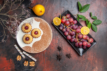 top view yummy little cookies with grapes on a dark background cake sweet biscuit sugar