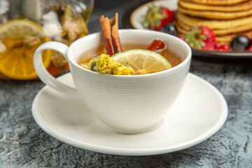 front view cup of tea with pancakes and fruits on the dark background morning breakfast food