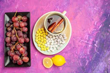 top view cup of tea with fresh grapes on pink background fruit candy sweet colors