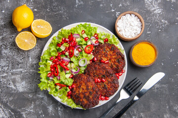 top view delicious fried cutlets with fresh salad on a dark backgruond meat food dish