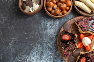 top view cake slices with nuts and sweets on dark background dessert biscuit sweet