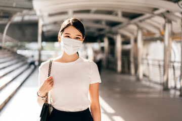 Adult business asian woman wear face mask for protect virus corona or covid19 at outdoor on day.