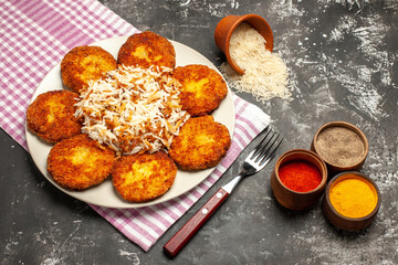 top view tasty fried cutlets with cooked rice on dark background rissole meat