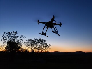 Obraz na płótnie Canvas Drone voando ao pôr do sol