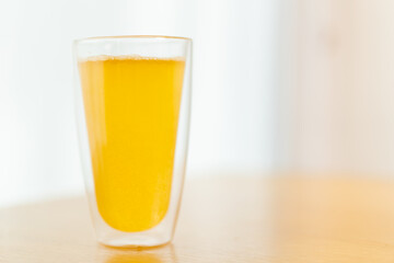 Tablet of calcium effervescent melting in a drinking water close up with copyspace.