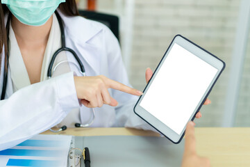 Doctor showing and pointing on tablet, empty blank screen tablet. Healthcare and wellness concept.