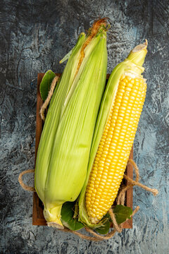 top view fresh raw corn yellow plant on dark-light background color green photo