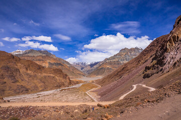 Beautiful view of cold desert arid landscape enroute off road connecting Kaza town with Chandratal Lake passing through Kunnzum Pass in Lahaul Spiti region of Himalayas in Himachal Pradesh, India.