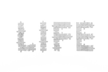 Word "Life" laid out by mosaic puzzle isolated on white background. Life as game concept. Life is puzzle