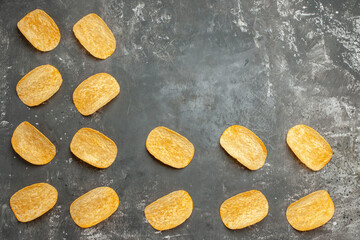 Top view of table decoration with homemade potato chips on the gray background