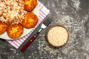 top view tasty fried cutlets with cooked rice on dark background rissole meat dish
