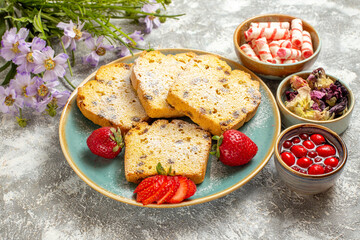 half-top view yummy cake slices with strawberries on light background pie cake sweet