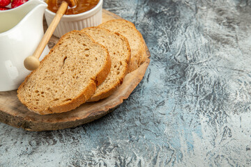 front view bread loafs with honey and strawberries on light background breakfast food fruit