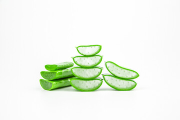 Slices of fresh aloe vera plant stacked and aloe vera stalk or leaves with water dropping isolate on white background.