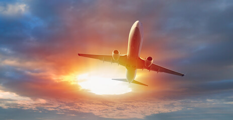 Airplane in the sky at amazing sunset