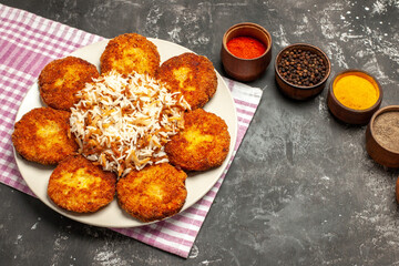 top view tasty fried cutlets with rice and seasonings on dark floor food meat rissole