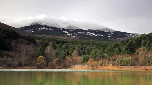 Time lapse of a mountain with snow behind a lake, Moncayo (Zaragoza). Arrival of winter December 21
