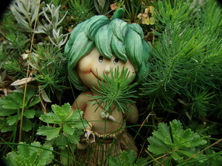 clay man hiding in the bushes