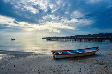 beautiful landscape of the blue sky, wooden boat, wooden bridgeon the Kohrong Samloem beach at Cambodia
