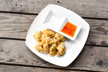 Corn Fritters with chilie souce on wooden background