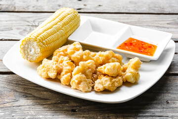 Corn Fritters with chilie souce on wooden background