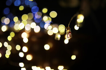 Christmas garland of glass bottles. New year and christmas concept. A garland of light bulbs with a beautiful light and bokeh