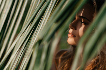 portrait of tender woman looking out of palm leaf Bali Indonesia